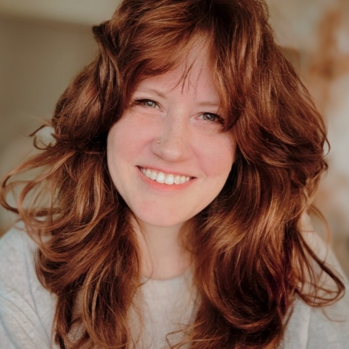 A photo Cassondra Roberts smiling and looking directly at the camera.