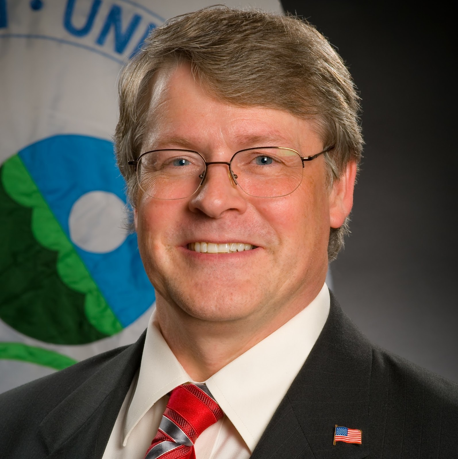 A photo Michael Roberts smiling and looking directly at the camera.